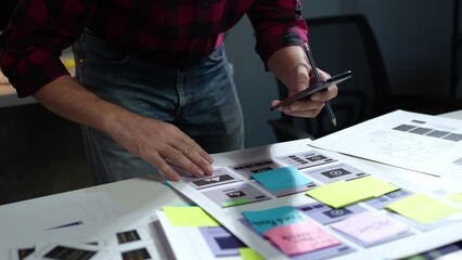 UX developers, UI designers think about designing creative mobile app interface layouts Application planning sketch Prototype development process with customer code and color code online business work