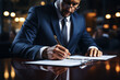 © Ph2023AI - Middle age man in a business suit is signing a document on a clipboard with a pen, with a blurred background of a busy, upscale office environment.