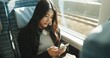 © D Lahoud/peopleimages.com - Japan woman, travel and train on smartphone, social media and public transportation on metro bullet. Person, cellphone and online on fast vehicle for weekend trip and commute in tokyo for adventure