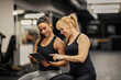 © dusanpetkovic1 - A female trainer is showing progress to a sportswoman on tablet ina gym.