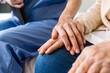 Close-up senior Asian woman hand with her caregiver helping hands, Caregiver visit at home. Home health care and nursing home concept.