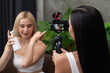© InfiniteFlow - Two beautiful content creator making natural beauty and cosmetic tutorial on green plant leave garden video. Beauty blogger showing how to beauty care to social medial audience by selfie stick. Blithe