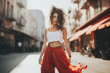 Young Girl In Modern Style Dancing On The City Streets And Looking At Camera