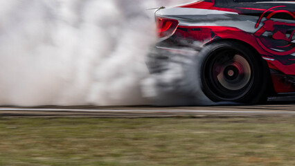 Wall Mural - Blurred car drifting diffusion race drift car with lots of smoke from burning tires on speed track, Professional driver drifting car on race track with smoke.