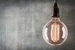 © ttonaorh - Vintage light bulb on grunge wall background with copy space