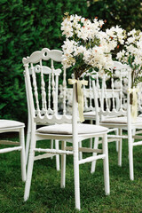 Wall Mural -  wedding chair decorated with white flowers in nature.Close-up