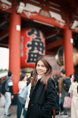 Wall Mural - Tourist woman visit Sensoji Temple or Asakusa Kannon Temple is a Buddhist temple located in Asakusa, Tokyo Japan. Japanese sentence on red lantern means Thunder gate.