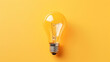Light bulb on yellow background, top view. Creative idea concept