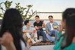 © Prathankarnpap - Group of happy friends talking and sharing nice moments together at the rooftop party