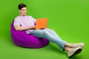 Sticker - Full length photo of successful man dressed stylish clothes sitting soft chair empty space isolated on green color background