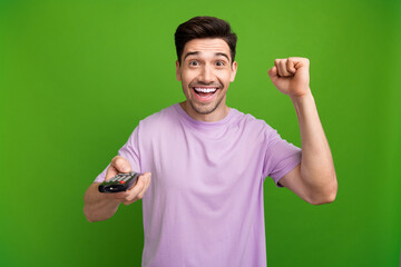 Sticker - Portrait of satisfied person with stylish haircut wear violet t-shirt watch football match on tv isolated on green color background