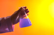 © Tuan  Nguyen  - Minimal scene of a female scientist with medical glove holding a beaker containing purple liquid. Gradient background. Medicine experiment and chemical biology study in science laboratory research