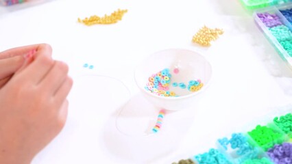 Canvas Print - Young Girl Engrossed in Crafting with Colorful Clay Beads