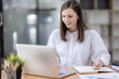 © David - Young business hispanic woman work on laptop desk doing math finance on an office desk, tax, report, accounting, statistics, and analytical research concept
