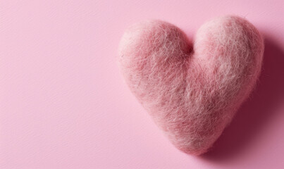 Wall Mural - A cute hand made felted love heart on a pink background for Valentine's day