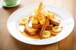 french toast with banana slices and caramel sauce
