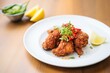 © stickerside - spicy fried chicken with chili flakes and lemon wedge