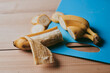 © amixstudio - Close-up of peeled sliced banana on wooden table background