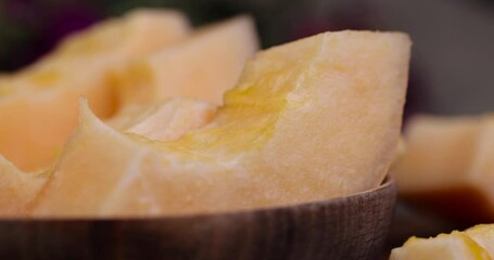 Sticker - sliced orange melon close-up, delicious soft and ripe food melon on the table