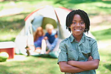 Wall Mural - Child, portrait and happy on adventure at campground, joy and relaxing on vacation or holiday. Black male person, smiling and face or confident in park, childhood and summer or freedom in nature