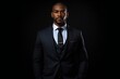 portrait of a businessman person in full height. full body seen. wearing a business suit. handsome black american man. looking forward black background