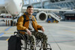 Smiling disabled male traveler sitting in wheelchair at the airport. Travel, vacation concept