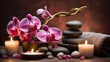 Fototapeta Kwiaty - Aromatherapy, spa, beauty treatment and wellness background with massage pebbles, orchid flowers, towels, cosmetic products and burning candles.