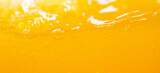 Close up bright orange juice splash texture for health and nature waves, Beautiful waves curve and little bubbles smooth for garphic design and background