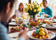 © pilipphoto - Happy multi generational family having Easter dinner together, table setting with traditional food and spring flowers for Easter celebration