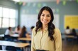 © JAYDESIGNZ - a photo portrait of a beautiful young female mexican american school teacher standing in the classroom. students sitting and walking in the break. blurry background behind