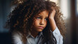A thoughtful young girl with curly hair looking away.