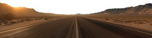 Vast Empty Highway Leading To The Horizon. Sunset Tones Casting A Warm Hue. Mountain Range In The Distant Horizon. Premium Pen Tool Cutout Transparent Background PNG.
