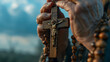 Close-up of the hands of an old man holding a rosary and a cross.