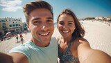 Fototapeta Do akwarium - a happy couple, a guy and a girl of European origin, smiling at the camera, walking along the beach by the sea, a guy and a girl taking selfies, a trip of a couple in love, a family at sea
