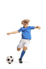 Wall Mural - Boy in a football kit kicking a ball