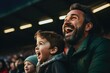 Father and son cheering in football stadium