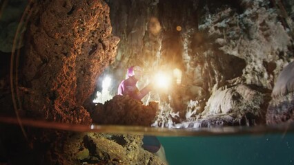 Sticker - Cave freediving. Freediver swims underwater and explores intricate labyrinths of the cave in the West Papua, Indonesia