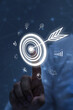 © Urupong - Concept of business strategy and future sustainable business finance action plan. Hand holding target board for creative and set up business objective target and success and business goals, vertical