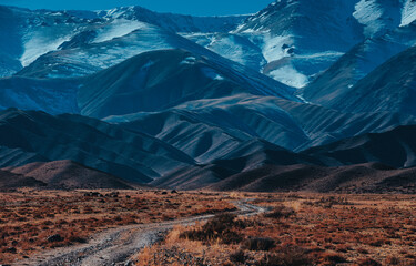 Canvas Print - Picturesque mountain landscape with dirt road in autumn