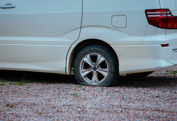 Canvas Print - Flat tire on offroad parked car