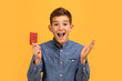 Surprised Teen Boy Holding Credit Card And Exclaiming With Joy