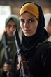shot of a young woman holding a toy gun after training with other rebels