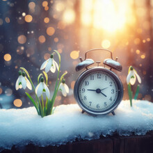 Alarm Clock In Melting Snow On The Street With Snowdrops On Nature Background. Ai Generative