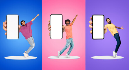 Wall Mural - Happy Multiethnic Guys Dancing With Big Blank Smartphones In Hands