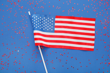 USA flag and confetti on blue background. Independence Day celebration