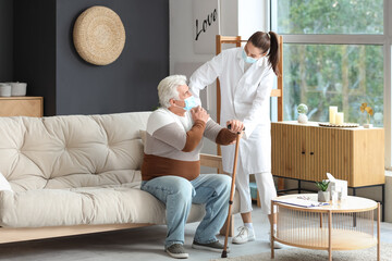 Poster - Senior man with stick and nurse in medical masks at home