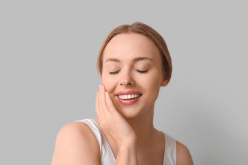 Poster - Beautiful young woman on grey background