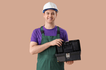 Poster - Male electrician with bag of tools on brown background