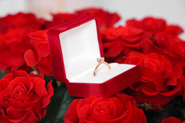 Wall Mural - Box with engagement ring on bouquet of roses, closeup. Valentine's Day celebrations