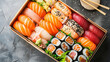 various kinds of sushi in a takeaway box, top view
